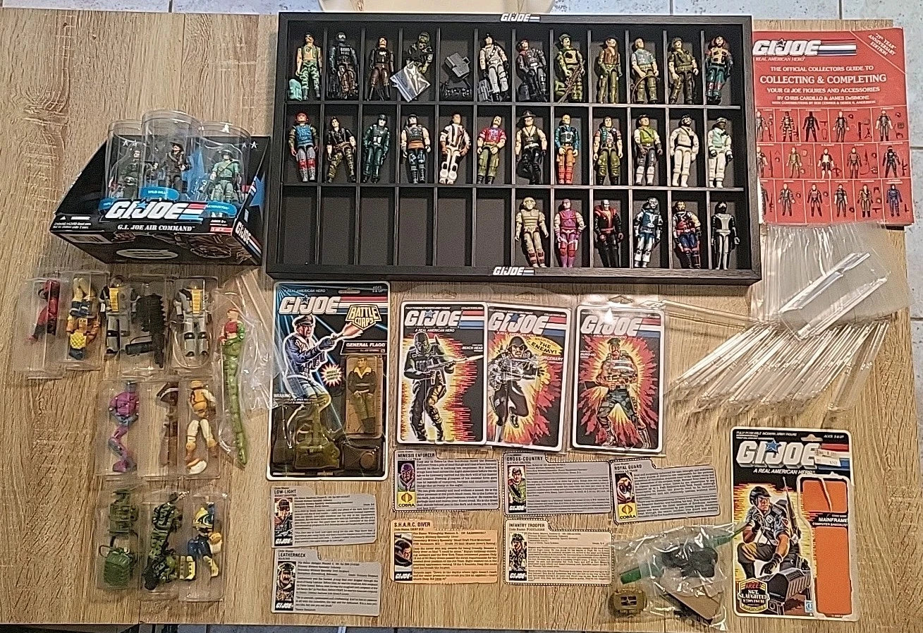 Vintage 1980s action figures found in a storage box including Star Wars and other classic toys