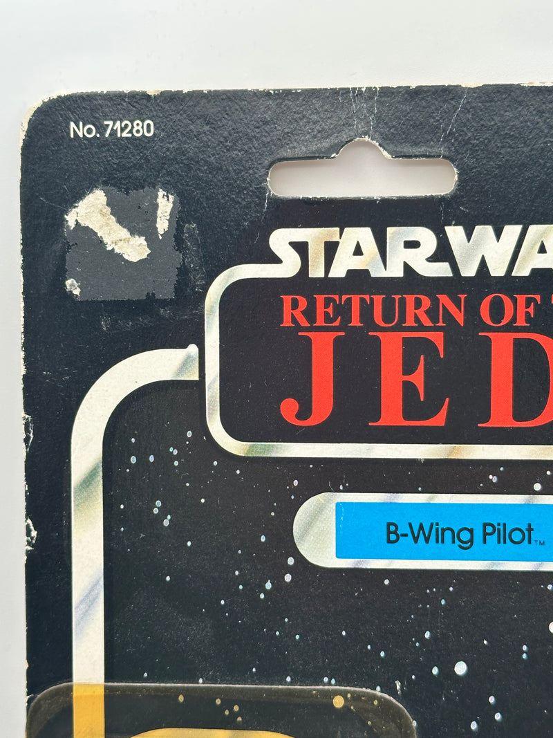 1983 Kenner Star Wars B-Wing Pilot MOC front view 77 back card
Vintage Star Wars B-Wing Pilot sealed figure bubble close-up
Return of the Jedi B-Wing Pilot cardback collect all 77 layout
Kenner B-Wing Pilot figure bubble clarity and yellowing detail
Star Wars B-Wing Pilot card edge wear and corner condition close-up
Vintage Kenner Star Wars cardback figure lineup detail 77 back
B-Wing Pilot punch hole condition close-up vintage Kenner
1983 Kenner B-Wing Pilot packaging back barcode and proof of purchase sea