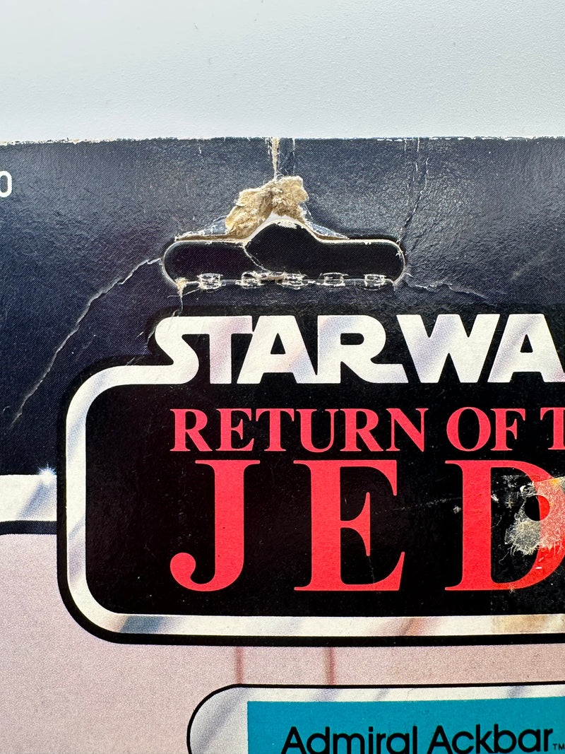Vintage 1983 Kenner Star Wars Admiral Ackbar Return of the Jedi 65 back MOC sealed action figure with coin offer, yellowed bubble with visible crack, unpunched card with hanger wear, front view collectible
