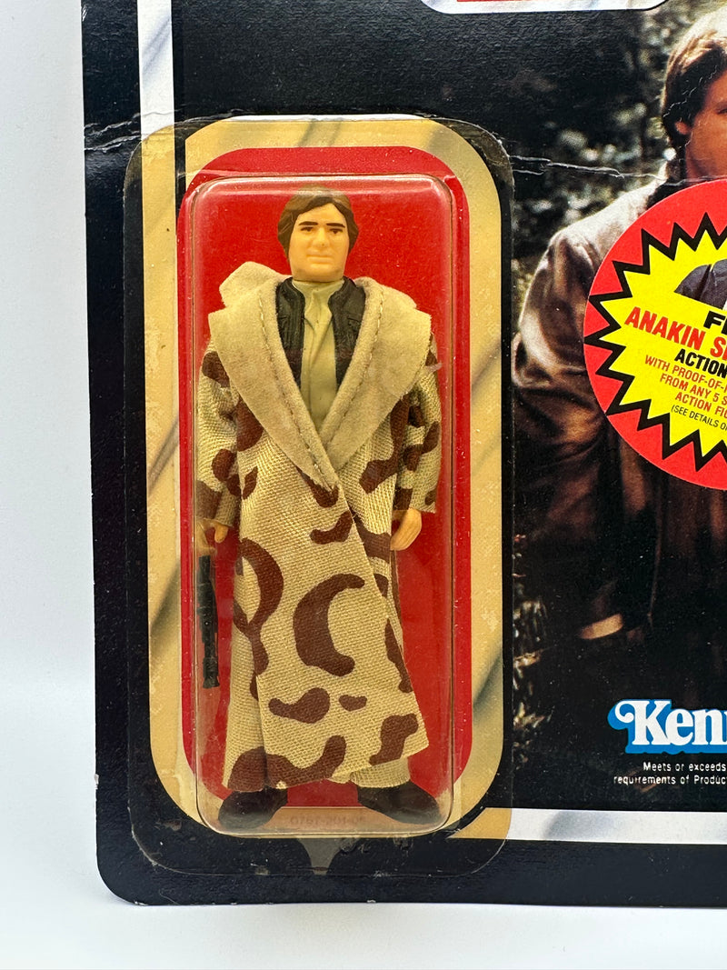 Han Solo Trench Coat ROTJ 77 back unpunched MOC with Anakin sticker front view
Close-up Han Solo figure sealed in original Kenner bubble
Anakin Skywalker offer sticker detail May 30 1985
ROTJ 77 back Collect All 77 lineup
Side profile showing amber bubble tone
Unpunched hanger detail with light stress
Full front Han Solo trench coat MOC
Back of card Kenner checklist