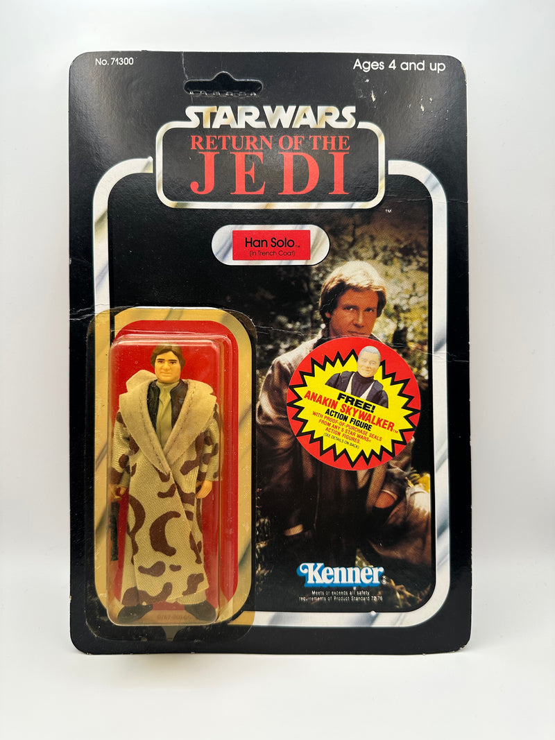 Han Solo Trench Coat ROTJ 77 back unpunched MOC with Anakin sticker front view
Close-up Han Solo figure sealed in original Kenner bubble
Anakin Skywalker offer sticker detail May 30 1985
ROTJ 77 back Collect All 77 lineup
Side profile showing amber bubble tone
Unpunched hanger detail with light stress
Full front Han Solo trench coat MOC
Back of card Kenner checklist